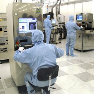 Microchip manufacture. View of a clean room in a factory making microprocessor circuits. Extreme clean room conditions are needed because the smallest piece of dust can ruin a microcircuit during manufacture by shorting between two electrical paths. Photographed at JSC Mikron, the largest such facility in Russia.